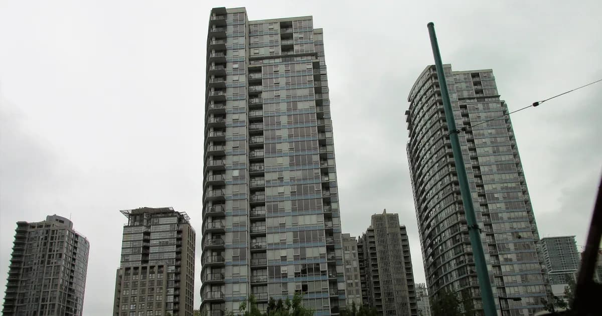 Concrete condo towers in Vancouver under an overcast sky